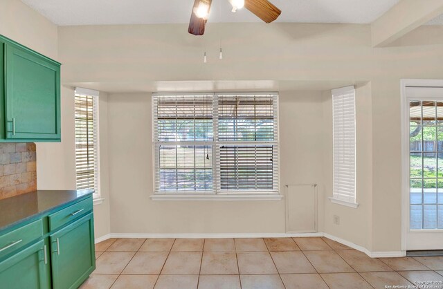 1314 Acorn, Hondo, TX 78861 - unfurnished dining area with ceiling fan, light tile patterned floors, and baseboards