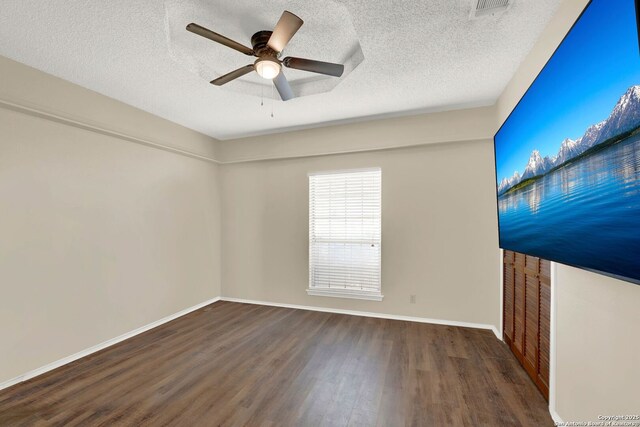 1314 Acorn, Hondo, TX 78861 - unfurnished room with wood finished floors, ceiling fan, baseboards, and a textured ceiling