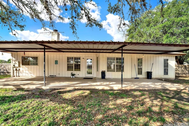 1314 Acorn, Hondo, TX 78861 - rear view of property with a chimney, a patio, fence, and board and batten siding