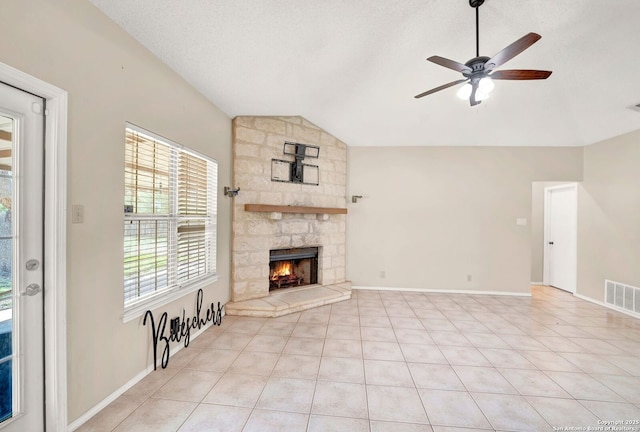 1314 Acorn, Hondo, TX 78861 - unfurnished living room with lofted ceiling, a ceiling fan, a fireplace, light tile patterned floors, and baseboards
