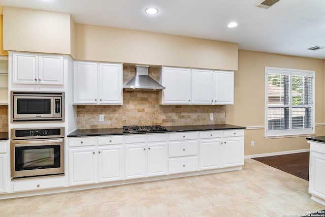 2426 Enfield Grove, San Antonio, TX 78231 - kitchen with stainless steel appliances, wall chimney exhaust hood, dark countertops, white cabinets, and recessed lighting