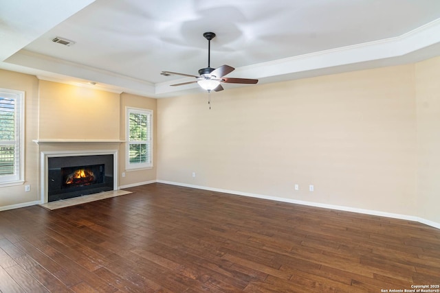 2426 Enfield Grove, San Antonio, TX 78231 - unfurnished living room with a raised ceiling, a ceiling fan, plenty of natural light, a fireplace with flush hearth, and crown molding