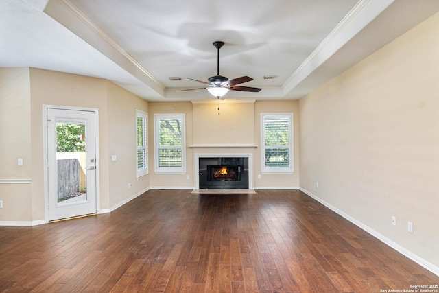 2426 Enfield Grove, San Antonio, TX 78231 - unfurnished living room with a tray ceiling, dark wood-type flooring, a ceiling fan, a fireplace with flush hearth, and ornamental molding