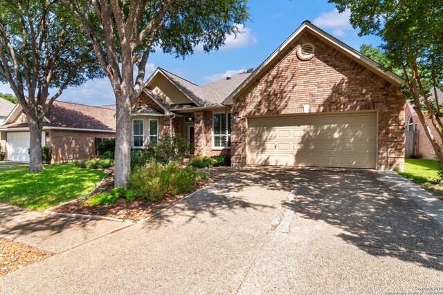 2426 Enfield Grove, San Antonio, TX 78231 - view of front facade with brick siding, asphalt driveway, a garage, and a front lawn