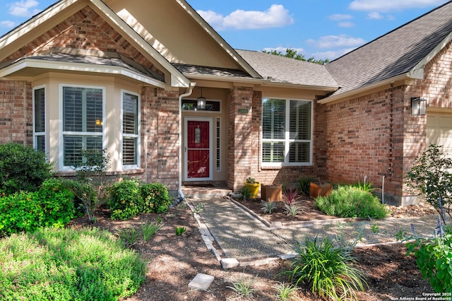 2426 Enfield Grove, San Antonio, TX 78231 - property entrance featuring brick siding, a shingled roof, and a garage