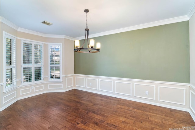 2426 Enfield Grove, San Antonio, TX 78231 - empty room featuring a chandelier, ornamental molding, wood finished floors, a decorative wall, and wainscoting