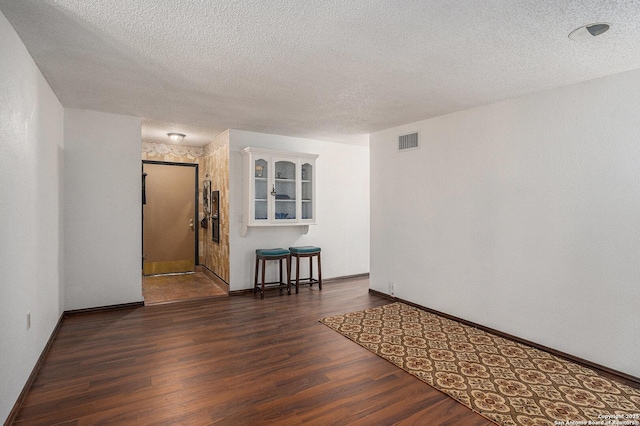 5954 Oak Run, San Antonio, TX 78247 - spare room featuring wood finished floors, a textured ceiling, and baseboards