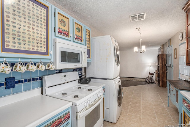 5954 Oak Run, San Antonio, TX 78247 - kitchen featuring white appliances, stacked washer / drying machine, light tile patterned floors, light countertops, and a chandelier