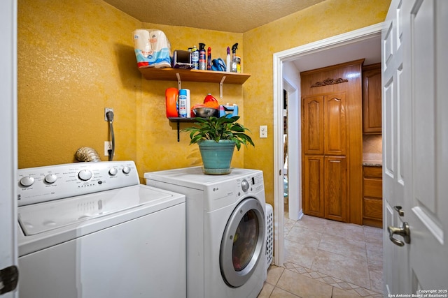 103 River Mdw, Castroville, TX 78009 - clothes washing area featuring washer and clothes dryer, light tile patterned floors, and a textured wall