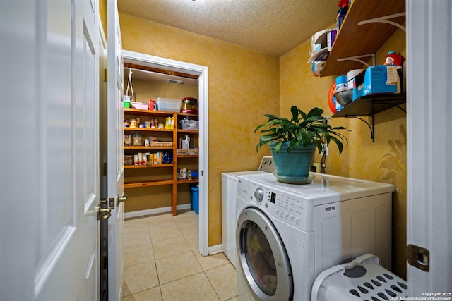 103 River Mdw, Castroville, TX 78009 - washroom featuring washer and clothes dryer, light tile patterned floors, and a textured ceiling
