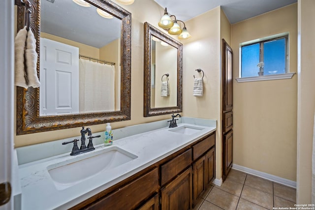 103 River Mdw, Castroville, TX 78009 - bathroom featuring tile patterned flooring, double vanity, and baseboards