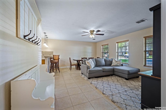 103 River Mdw, Castroville, TX 78009 - living area featuring light tile patterned flooring, ceiling fan, and baseboards