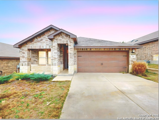 13051 Louberg Vly, San Antonio, TX 78253 - view of front facade with an attached garage, concrete driveway, stone siding, and brick siding