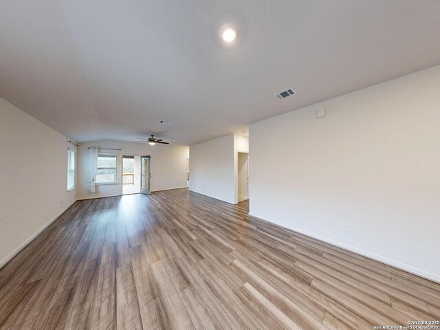 13051 Louberg Vly, San Antonio, TX 78253 - unfurnished living room featuring wood finished floors, baseboards, and ceiling fan