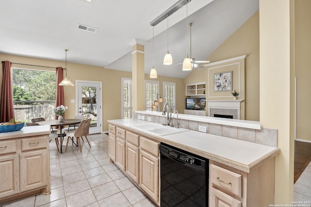 18852 Agin Ct, San Antonio, TX 78258 - kitchen featuring black dishwasher, light brown cabinetry, a sink, light countertops, and lofted ceiling