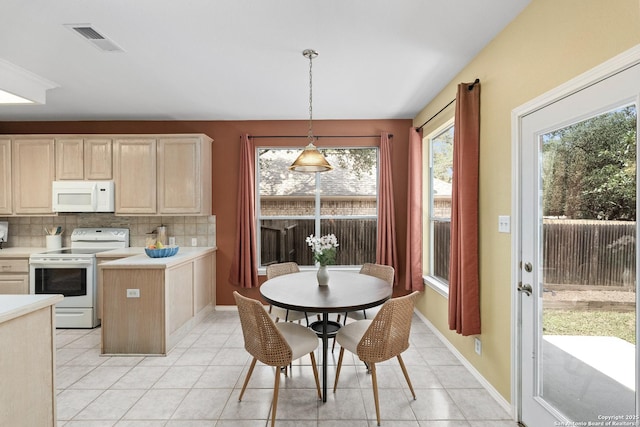 18852 Agin Ct, San Antonio, TX 78258 - dining space featuring light tile patterned flooring and baseboards