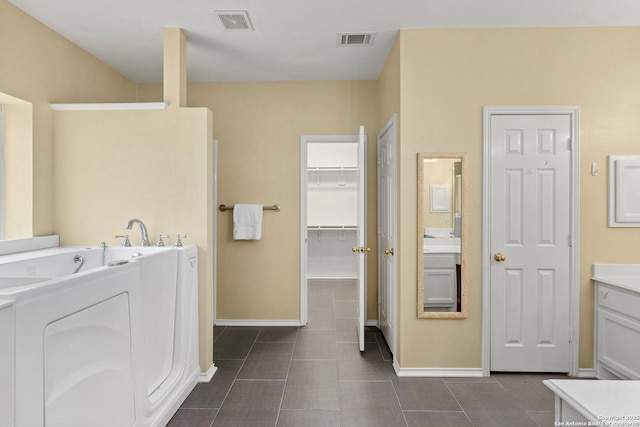 18852 Agin Ct, San Antonio, TX 78258 - washroom featuring baseboards, washer / dryer, and dark tile patterned flooring