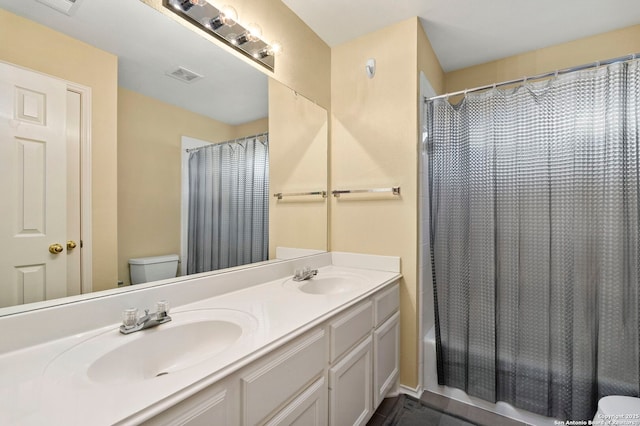 18852 Agin Ct, San Antonio, TX 78258 - bathroom featuring toilet, shower / bathtub combination with curtain, and double vanity