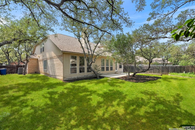 18852 Agin Ct, San Antonio, TX 78258 - back of house featuring central AC unit, roof with shingles, brick siding, and a patio area