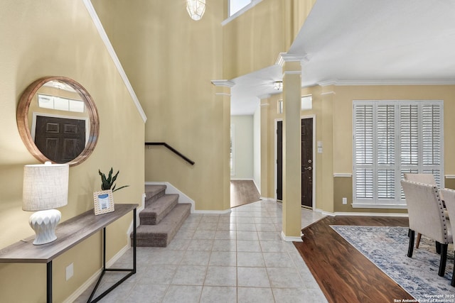 18852 Agin Ct, San Antonio, TX 78258 - foyer with stairs, crown molding, ornate columns, baseboards, and tile patterned floors