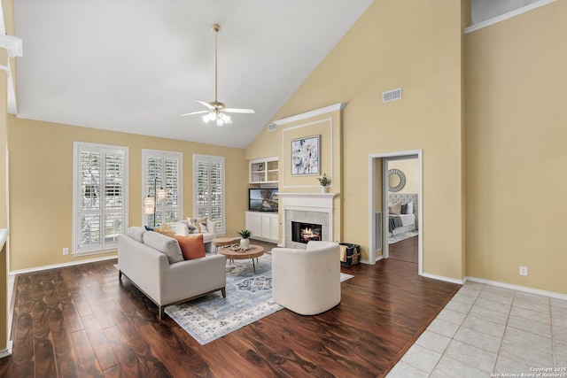 18852 Agin Ct, San Antonio, TX 78258 - living room featuring high vaulted ceiling, ceiling fan, a premium fireplace, baseboards, and wood finished floors
