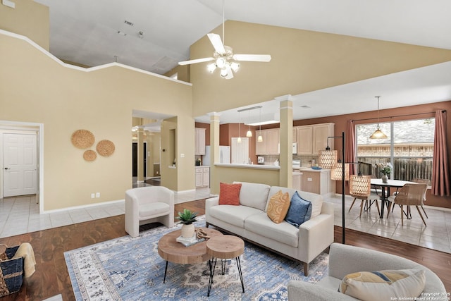 18852 Agin Ct, San Antonio, TX 78258 - living area featuring decorative columns, ceiling fan, light wood-type flooring, high vaulted ceiling, and baseboards