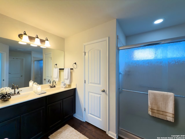 2494 Mccrae, New Braunfels, TX 78130 - bathroom with a shower with door, wood finished floors, and double vanity