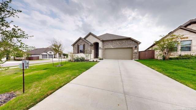 111 Old Glory, Kyle, TX 78640 - french provincial home with concrete driveway, an attached garage, and brick siding