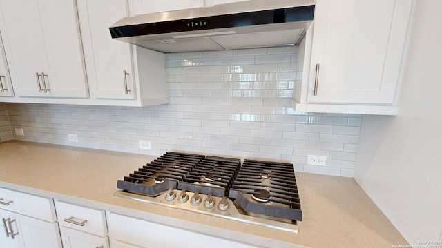 111 Old Glory, Kyle, TX 78640 - kitchen featuring stainless steel gas cooktop, under cabinet range hood, light countertops, and white cabinets