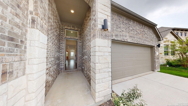 111 Old Glory, Kyle, TX 78640 - doorway to property featuring concrete driveway and stone siding