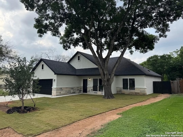view of front of property with stone siding, stucco siding, concrete driveway, and an attached garage