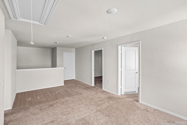 11947 Sand Wedge, San Antonio, TX 78221 - empty room featuring attic access, carpet flooring, baseboards, and a textured wall