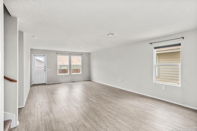 11947 Sand Wedge, San Antonio, TX 78221 - unfurnished room with wood finished floors, baseboards, and a textured ceiling