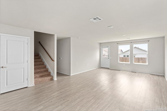 11947 Sand Wedge, San Antonio, TX 78221 - unfurnished living room featuring light wood-style flooring, stairs, and baseboards