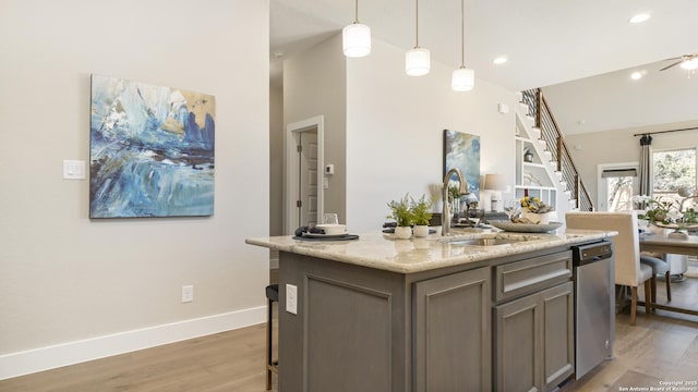 4207 Colina Crst, San Antonio, TX 78261 - kitchen featuring a center island with sink, dishwasher, pendant lighting, light stone countertops, and a sink