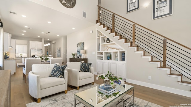 4207 Colina Crst, San Antonio, TX 78261 - living area with light wood finished floors, recessed lighting, and stairway