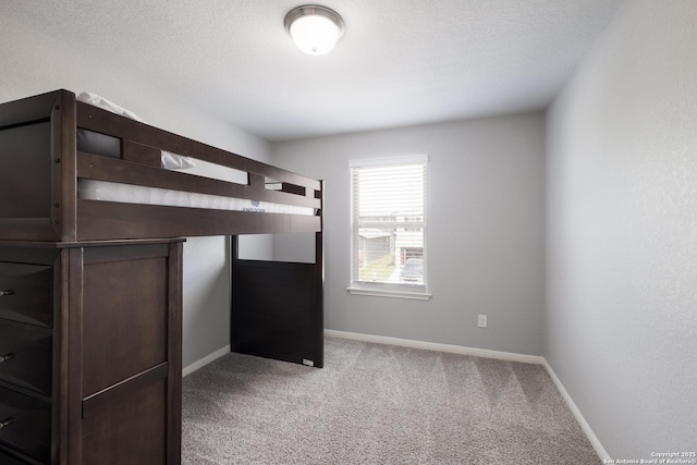 11510 Bakersfield Pass, San Antonio, TX 78245 - unfurnished bedroom featuring carpet, baseboards, and a textured ceiling