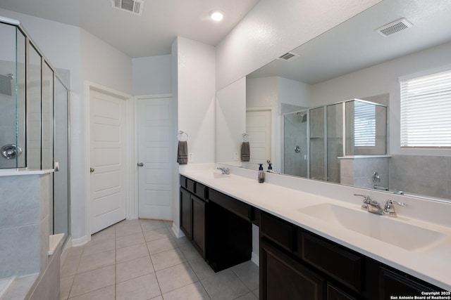 11510 Bakersfield Pass, San Antonio, TX 78245 - bathroom with a shower stall, tile patterned floors, and double vanity