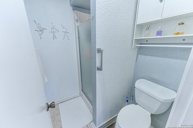 5003 Rustic Rdg, San Antonio, TX 78228 - full bath featuring a shower stall, toilet, a textured wall, and tile patterned floors