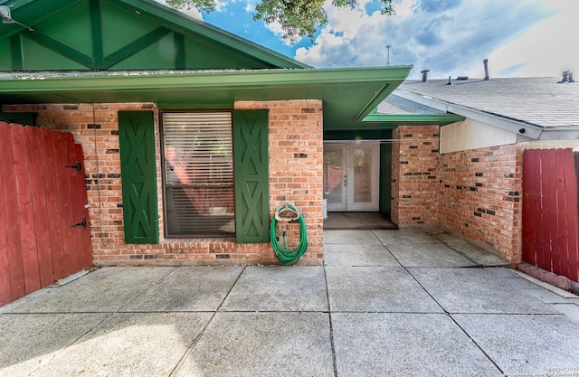 5003 Rustic Rdg, San Antonio, TX 78228 - entrance to property featuring brick siding, fence, french doors, and a patio area