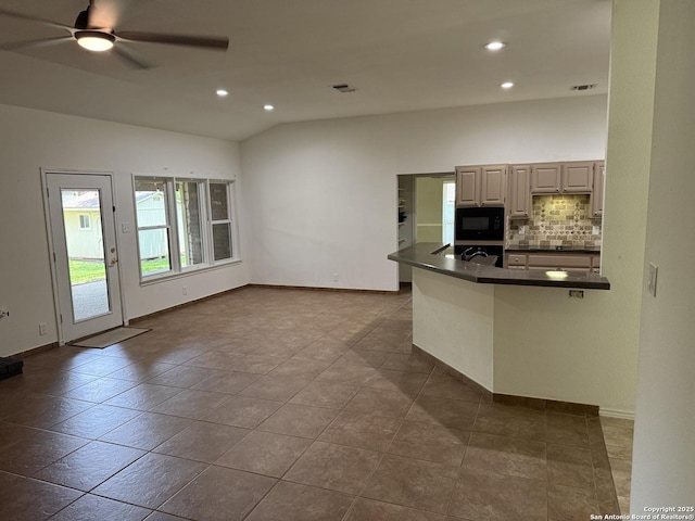 2411 Kelso, San Antonio, TX 78248 - kitchen featuring black microwave, dark countertops, oven, tasteful backsplash, and a peninsula