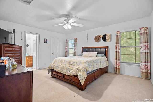 1130 Stone Gdn, New Braunfels, TX 78130 - bedroom with light colored carpet, a ceiling fan, ensuite bathroom, and baseboards