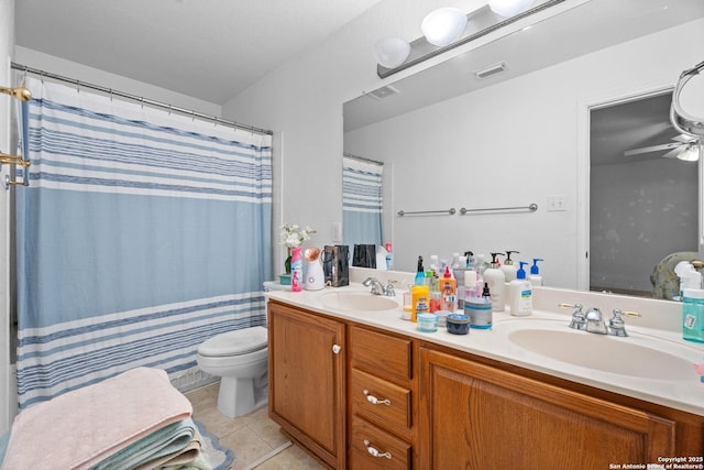 1130 Stone Gdn, New Braunfels, TX 78130 - full bathroom featuring double vanity, tile patterned floors, toilet, and ceiling fan