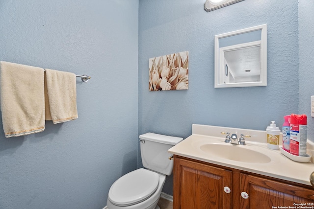 1130 Stone Gdn, New Braunfels, TX 78130 - bathroom featuring vanity, toilet, and a textured wall