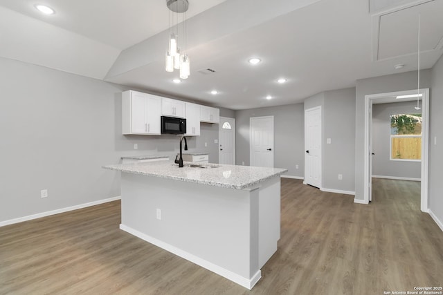 519 W Mitchell, San Antonio, TX 78204 - kitchen with black microwave, a sink, baseboards, white cabinets, and recessed lighting