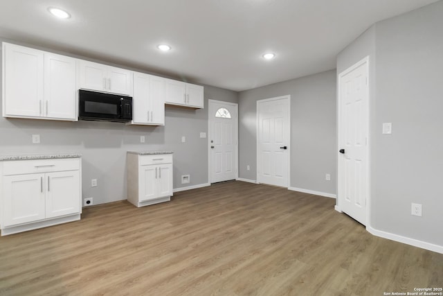 519 W Mitchell, San Antonio, TX 78204 - kitchen with black microwave, white cabinets, light wood finished floors, baseboards, and recessed lighting