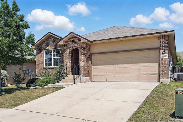 view of front facade with brick siding, central air condition unit, driveway, and an attached garage