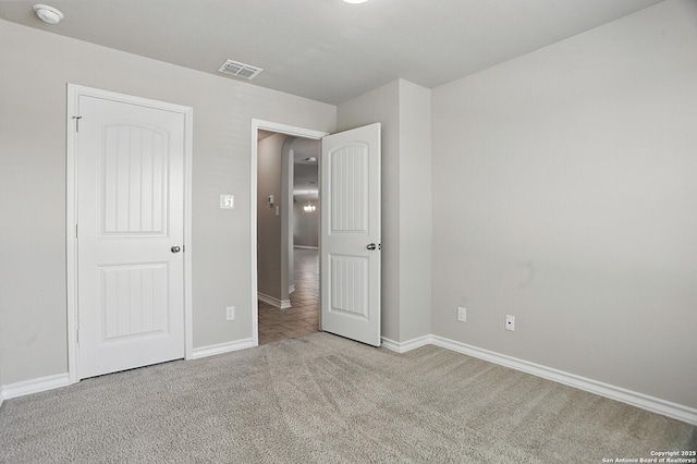 unfurnished bedroom with carpet flooring and baseboards