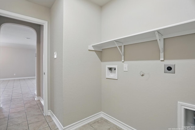 laundry area featuring electric dryer hookup, light tile patterned floors, washer hookup, hookup for a gas dryer, and baseboards
