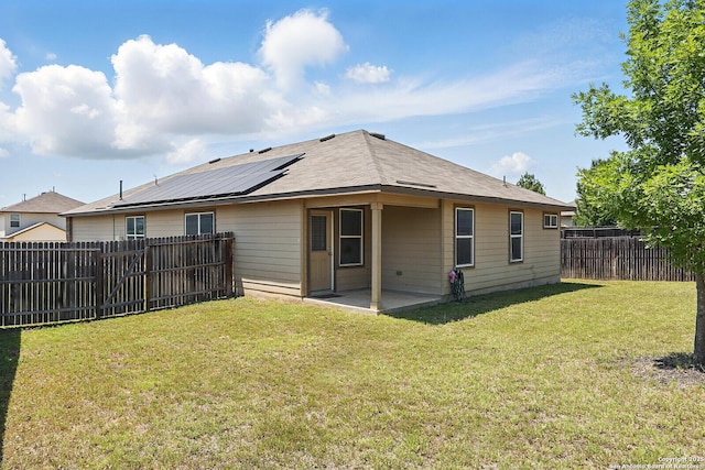 rear view of house featuring a patio area and solar panels